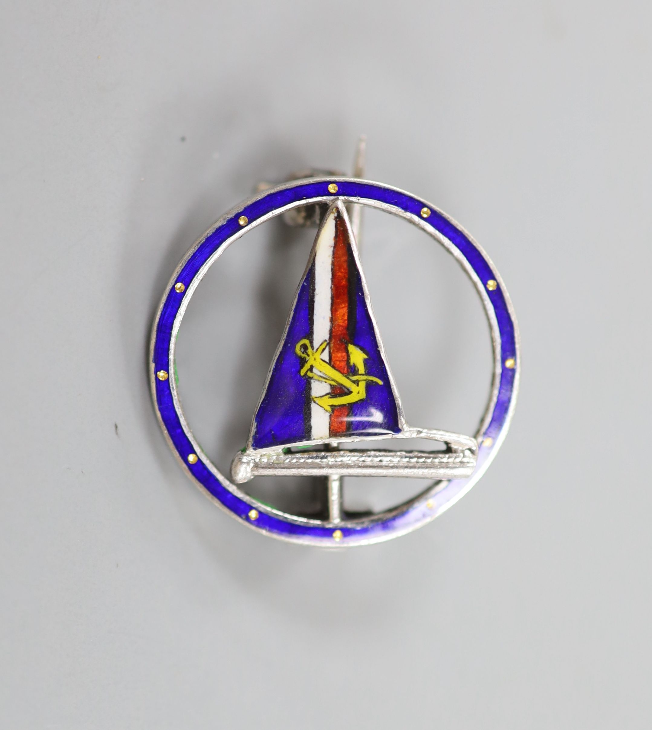 A white metal (stamped silver) and polychrome enamel yachting brooch, 20mm.